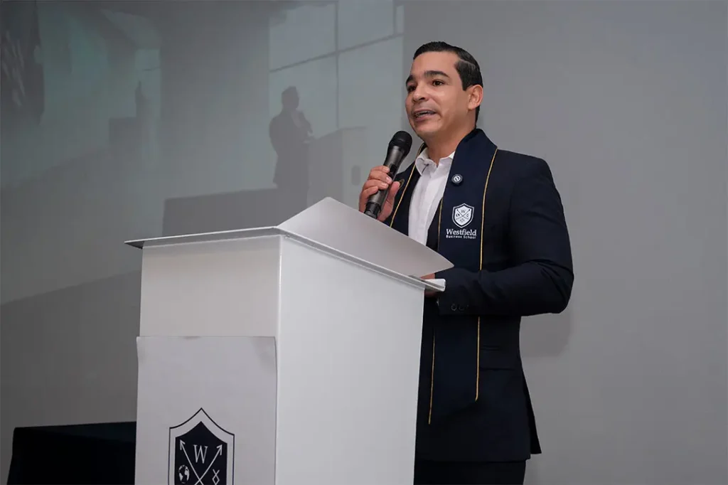 Graduation moments from Westfield Business School Cohort 65 across Medellín, Miami, and virtual participation, featuring MBA and Executive MBA graduates.
